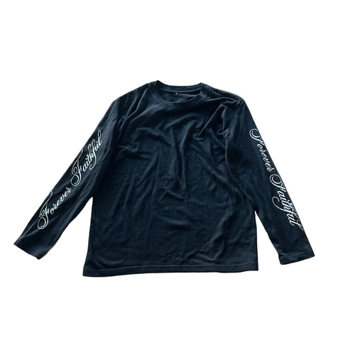 Black long-sleeve shirt with white text on a concrete floor